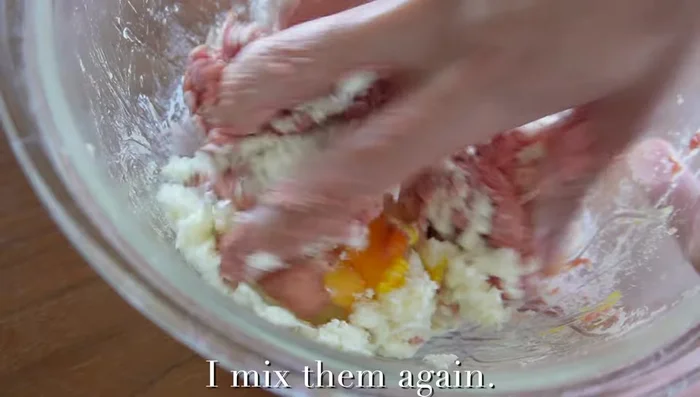 Add the cooled onions, breadcrumbs, and egg to the meat mixture. Mix until everything is well combined and the mixture becomes white and sticky.