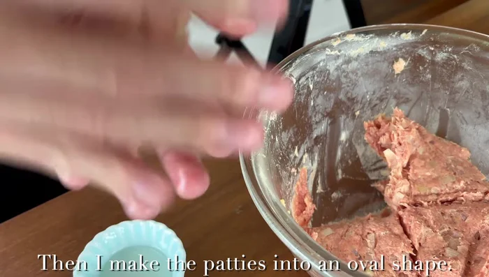 Heat some oil in a pan. Gently place the patties on the pan. It is important to grease your hands before handling the patties to create a smooth surface and prevent the juice from escaping.