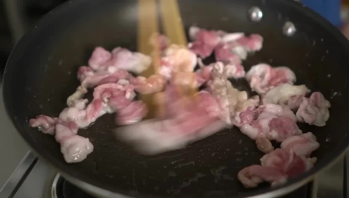 Stir-fry the pork until almost fully changed color.