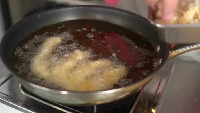 Fry the chicken in batches, ensuring not to overcrowd the pan. Fry for about 2 minutes per side, until golden brown.