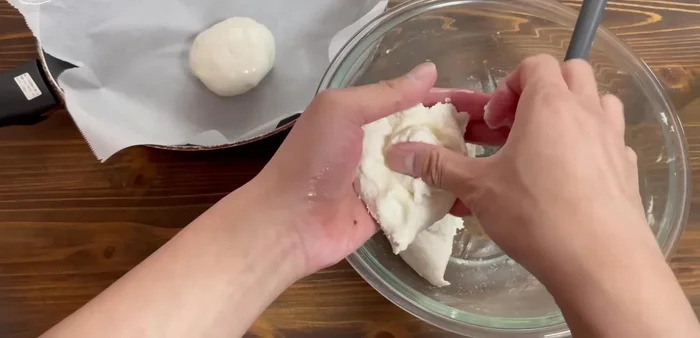 Place the dough balls in the prepared frying pan.