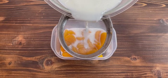 Strain the liquid mixture and pour it over the fruits in the Tupperware.
