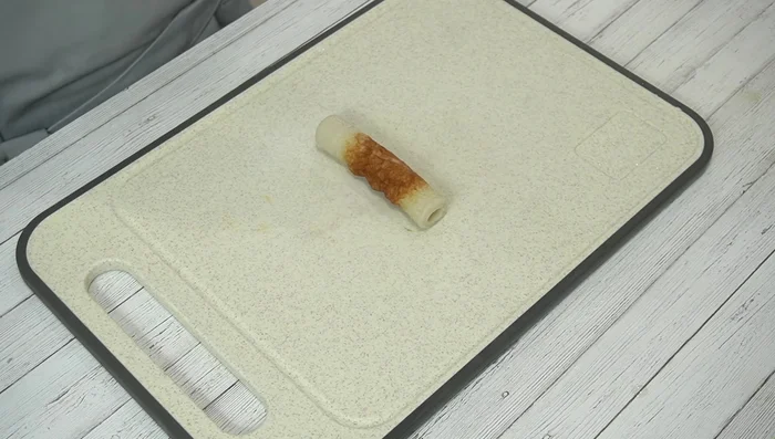 Cut the chikuwa: Cut each chikuwa lengthwise into two equal halves.