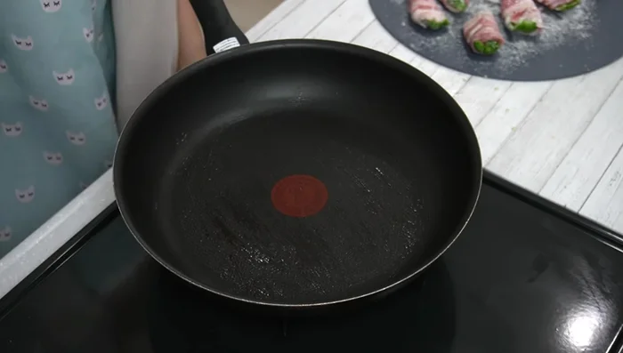 Cook the peppers: Heat oil in a frying pan over medium heat. Place the rolled peppers seam-side down in the pan. Cook until both sides are browned. Reduce heat to low, add water, cover, and steam for about 2 minutes. Remove excess moisture.
