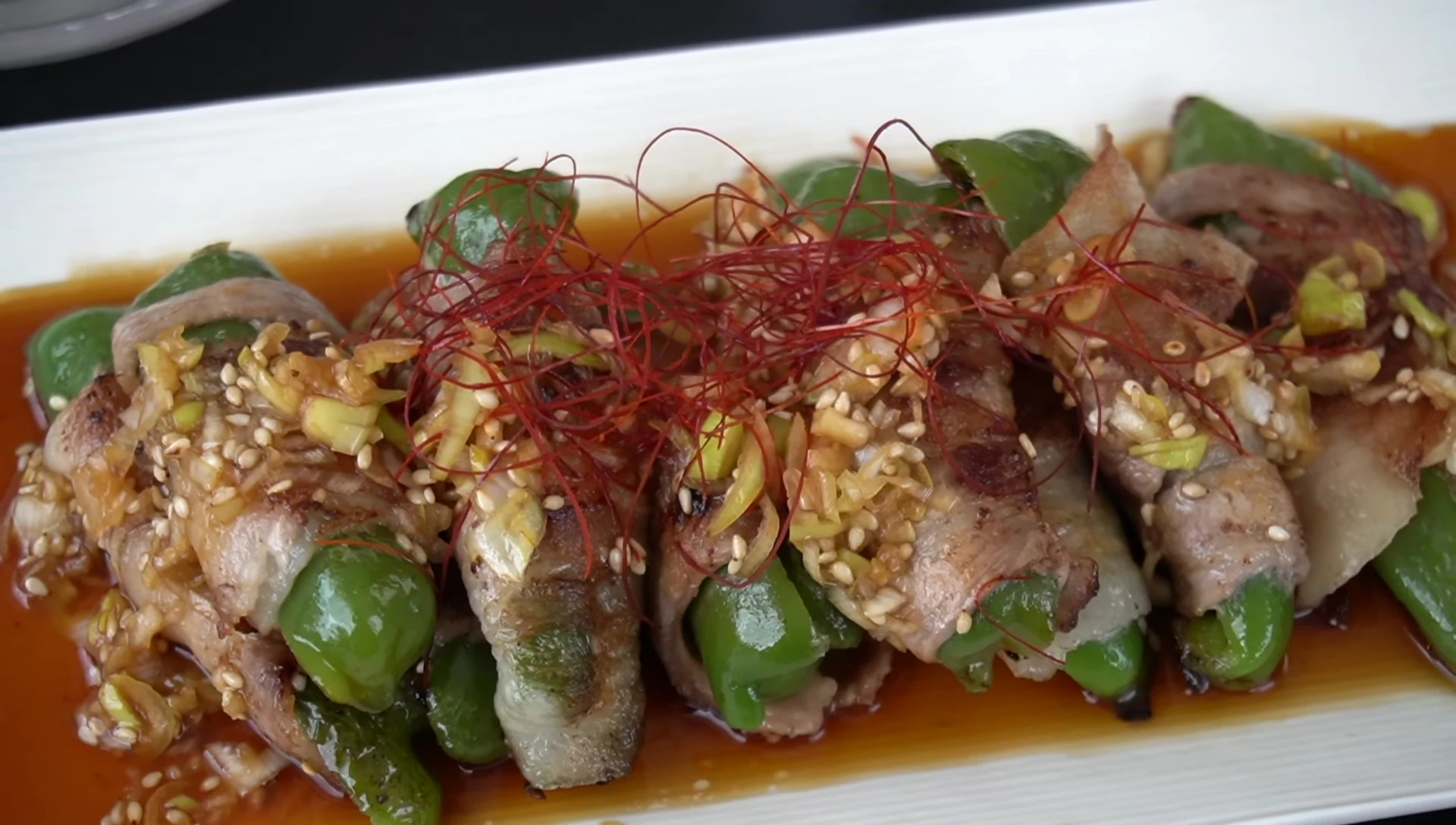 Juicy Pork-Wrapped Bell Peppers with Refreshing Onion Sauce