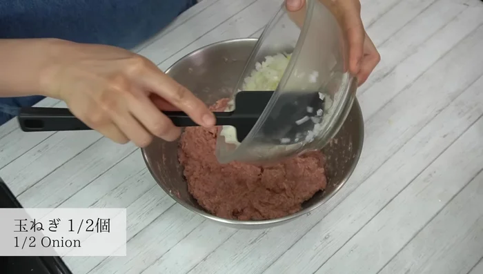 Add the cooled onions to the meat mixture and gently mix.