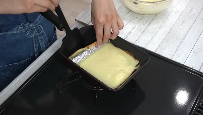 Roll up the first layer around the tube. Brush the open area with oil.