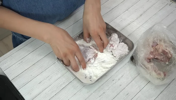 Coat the chicken pieces in the batter, ensuring even coverage.