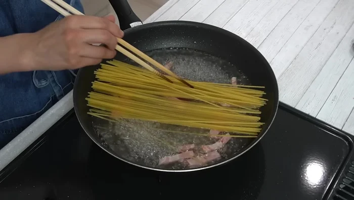 Add the pasta to the boiling water, ensuring it's fully submerged. Cook for 1 minute longer than the package instructions (about 10 minutes total), stirring occasionally to prevent sticking. Add more water if needed.