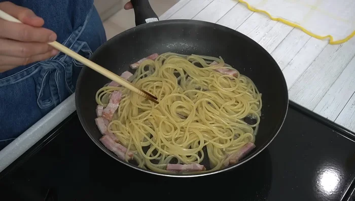 Once the pasta is cooked al dente, remove from heat. Place the pan on a damp cloth to cool slightly (about 1 minute).