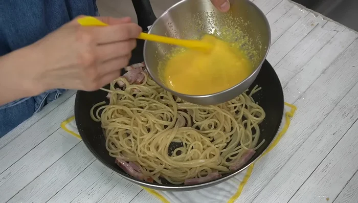 Pour the egg mixture over the cooked pasta.