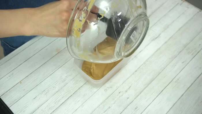 Pour the batter into the prepared Tupperware container. Gently tap the container to remove air bubbles.