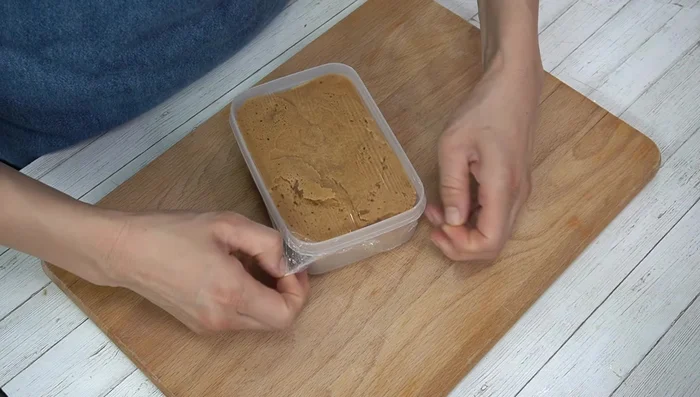 Carefully remove the plastic wrap and check if the bread is cooked through by inserting a toothpick or skewer into the center. If it comes out clean, it's done. If not, heat for a little longer.