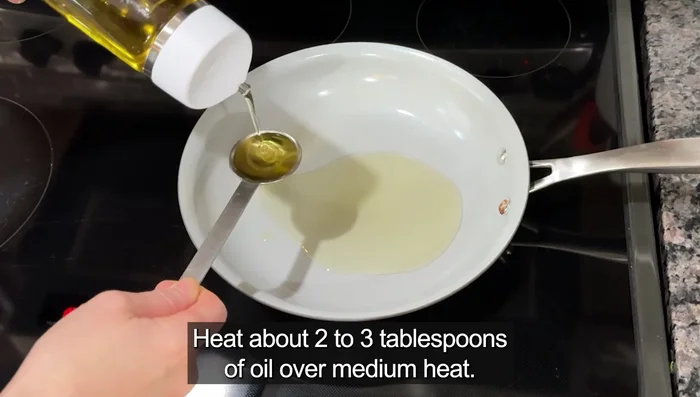 Heat about two to three tablespoons of oil over medium heat. Add 2 tbsp of chopped green onion, the dried veggie flakes, half the soup powder from the shin ramen packet, one teaspoon of minced garlic, and 1 tbsp of peanut butter.