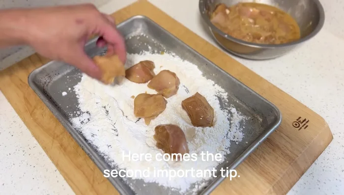 Coat the chicken in the starch mixture, ensuring even coverage. Let rest for a few minutes on a tray or cutting board to allow the starch to absorb moisture.