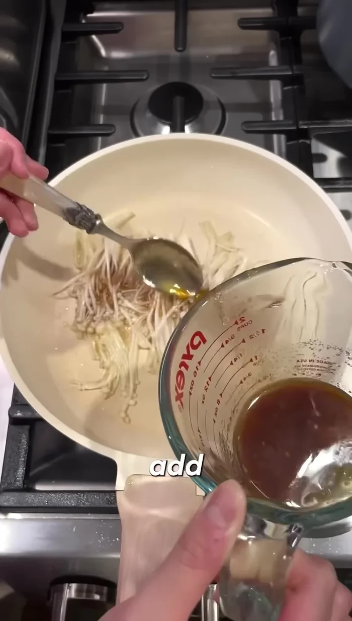 Add the sauce to the mushrooms. Add red peppers for extra spice (optional).