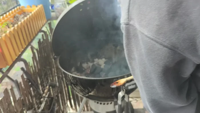 Preheat the Mangal grill attachment on the kettle grill.