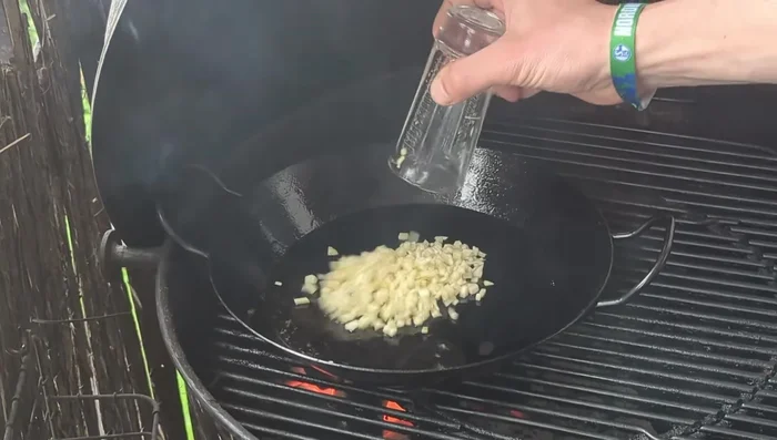Add a splash of dark sesame oil to the pan. Add finely chopped garlic and ginger.