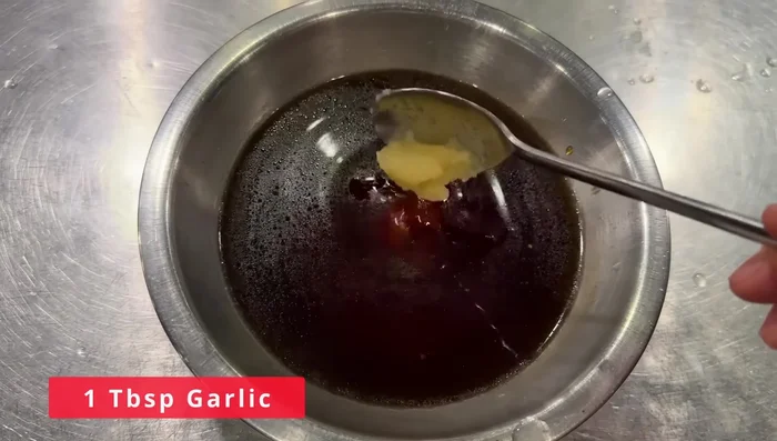In a separate bowl, whisk together 1 ¼ cup soy sauce, 1/3 cup sugar, 1 tbsp garlic, ½ tbsp ginger.