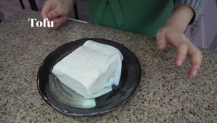 Wrap tofu in paper towels and microwave for 3 minutes to remove excess moisture. Let cool completely.