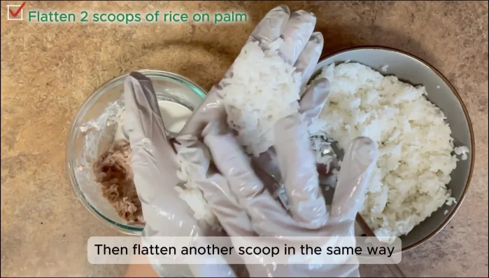 Shape rice balls: Flatten two scoops of rice. Add a spoonful of tuna mayo to one, top with the other scoop, and gently press into a ball.