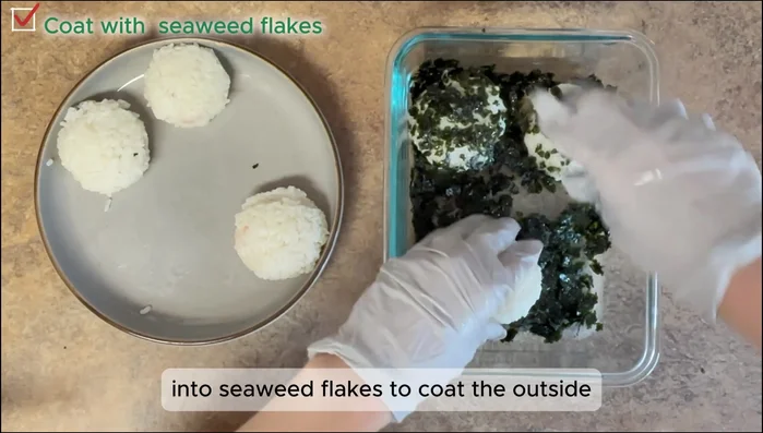 Option 1 (Seaweed coated): Gently press the finished rice balls into the crushed seaweed flakes to coat.
