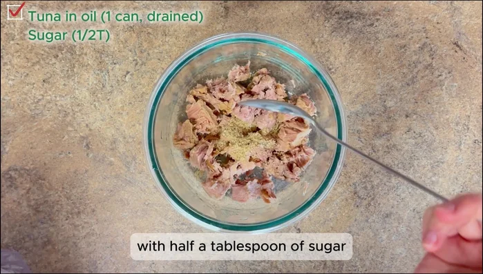 Drain oil from canned tuna. Mix tuna with sugar and mayonnaise.