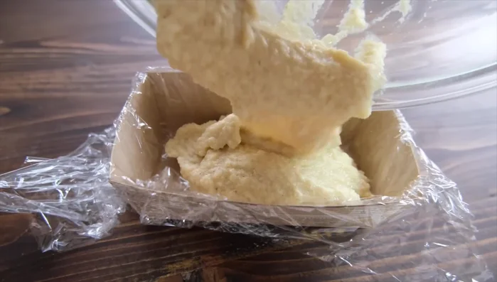 Pour the batter into the prepared mold and flatten slightly.