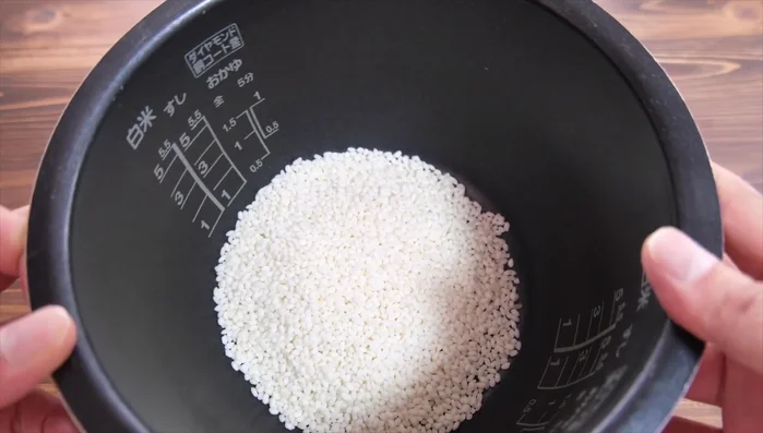 Rinse glutinous rice until the water runs clear. Add water (slightly less than usual for glutinous rice).