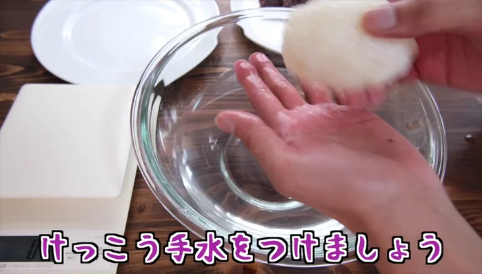 Wrap the red bean paste with the glutinous rice, shaping it into a ball. Add a little water if needed to help the rice stick together.