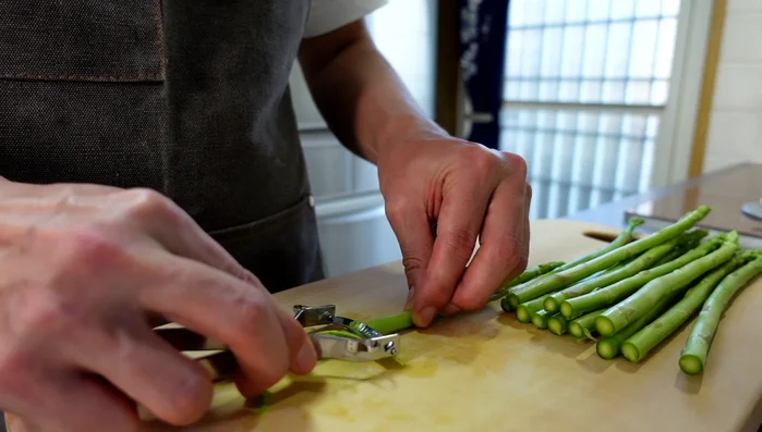 Peel about 3cm from the base of each asparagus spear using a peeler.