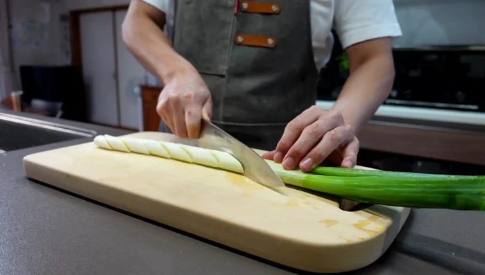 Thoroughly wash the long green onions, paying special attention to the root end where sand and mud may accumulate.