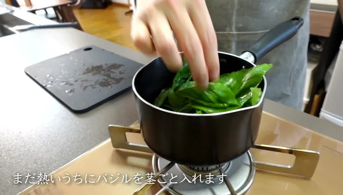 Add the basil stems to the hot marinade.