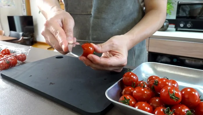Make a vertical cut on each cherry tomato to make peeling easier.