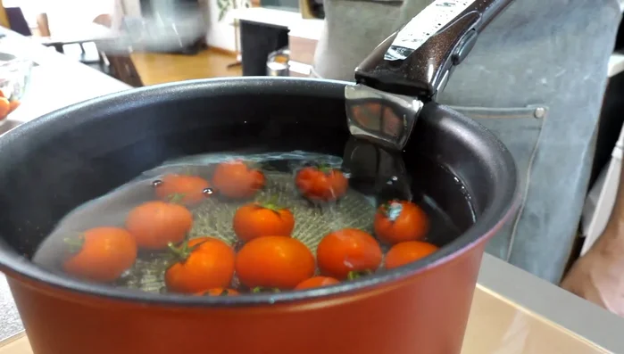 Immediately transfer the tomatoes to a bowl of cold water to cool them down.