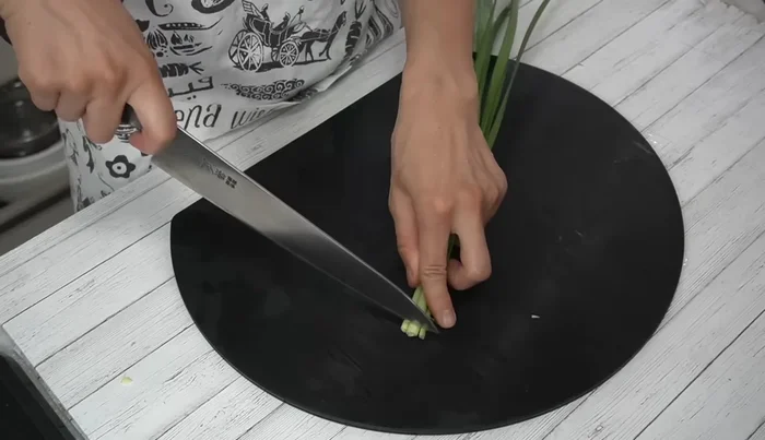 Cut the chives in half, and then finely chop them.