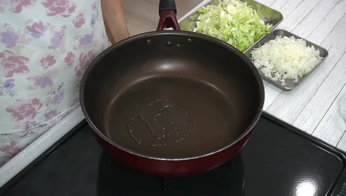 Fry ground meat with salt and pepper until 80-90% cooked. Add onion and cabbage; cook until vegetables are about half-cooked and slightly reduced.