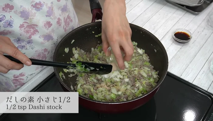 Season the cabbage mixture with mirin, sugar, dashi stock, and soy sauce. Mix well.