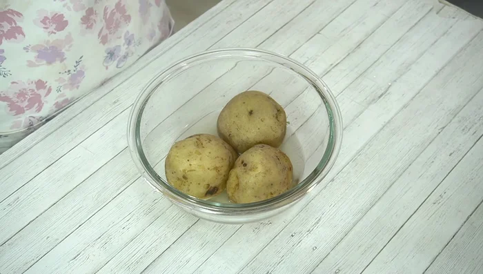 Remove potatoes from microwave, peel while hot, and mash.