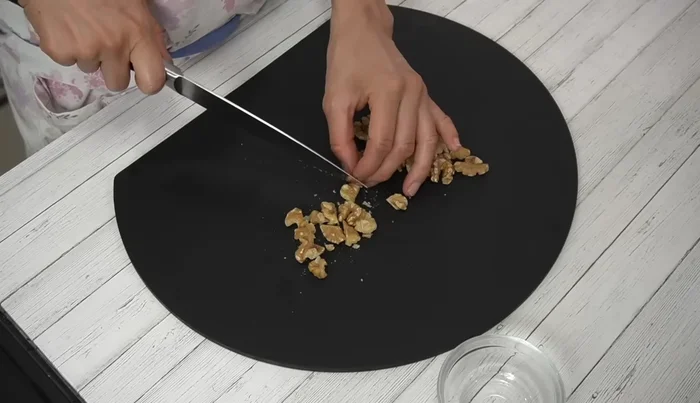 Add filling: Chop walnuts and mix with soaked dried fruits and orange peel. Add to dough, mix well, and let rise for another 30 minutes.