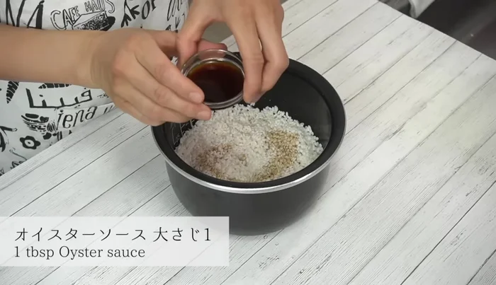 Add soy sauce, oyster sauce, sake, mirin, grated ginger, and sesame oil to the rice. Mix well to prevent stickiness.
