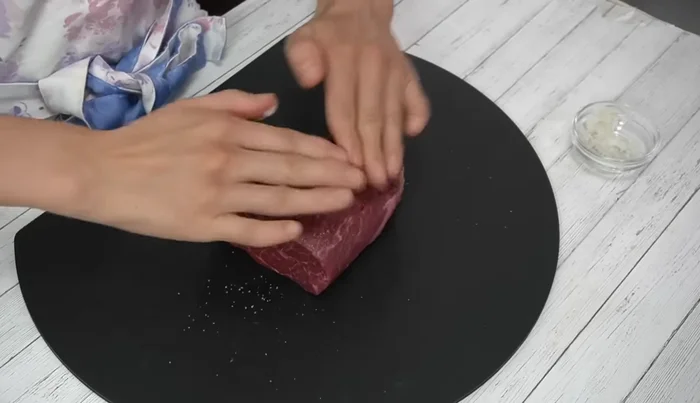 Season the meat generously with salt and black pepper, rubbing it all over.
