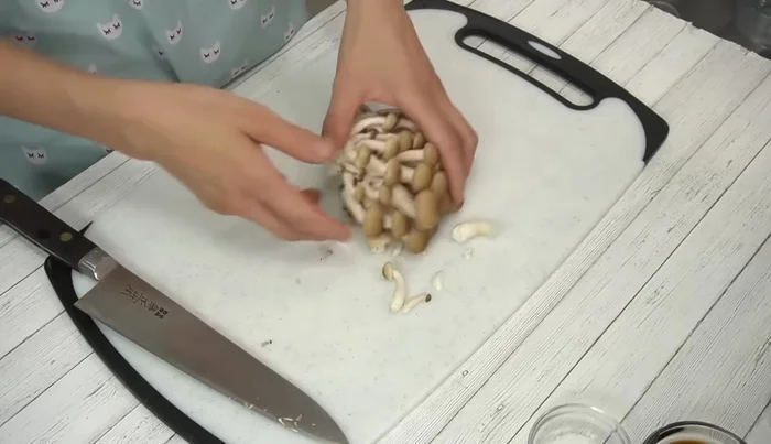 Cut the mushrooms. Remove stems from shiitake, loosen shimeji and maitake, then thinly slice.