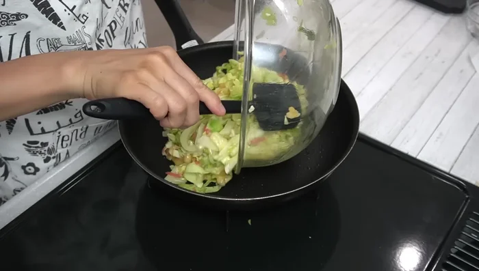 Pour the cabbage and egg mixture into the hot pan and spread evenly.
