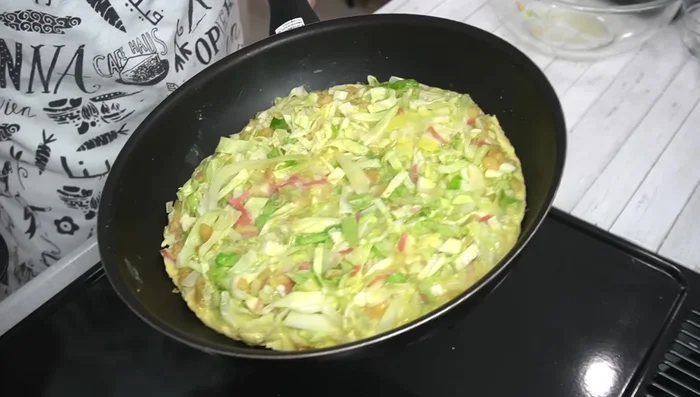 Cook over low to medium heat for about 4 minutes, or until the bottom is browned. Then, carefully flip and fold the omelette in half.