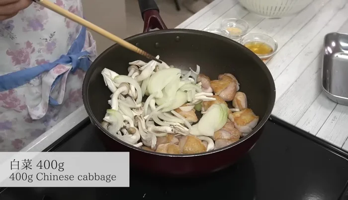 Add onions, shimeji mushrooms, and Chinese cabbage to the pan and stir-fry.