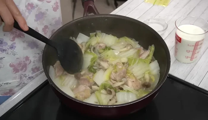 After 15 minutes, add milk and sliced cheese. Bring to a boil until the cheese melts.