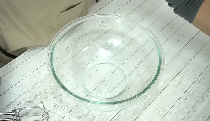 Beat eggs lightly, add granulated sugar, and mix quickly. Whip the egg mixture in a bowl set in hot water (60°C) for 3 minutes at high speed, then 1 minute at low speed.