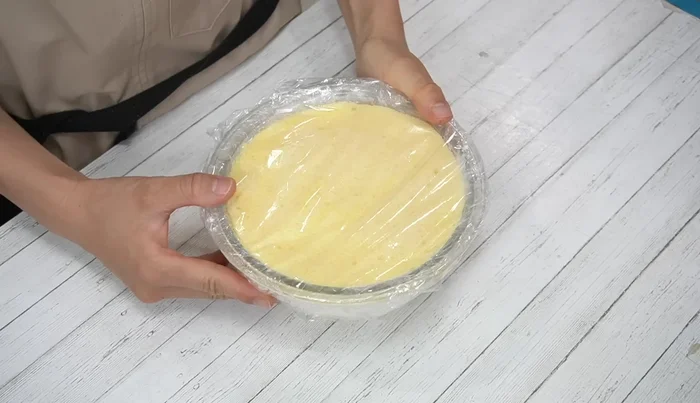 Chill the assembled cake in the refrigerator for 30 minutes. Then, carefully invert it onto a turntable or plate.