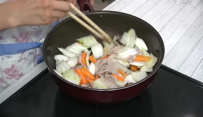 Add garlic and ginger, stir-fry, then pour in sake and stir quickly. Cover and steam-fry for 2 minutes on low-medium heat.
